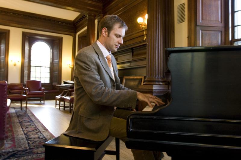 Professor Alexander Rehding was photographed by the grand piano at Phillips Brooks House.