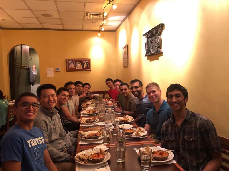 A large group of students eating at a long table