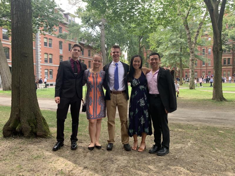 Five Harvard roommates posing for a picture in Harvard Yard 