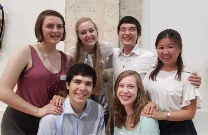 6 students, smiling together at the end of the summer.