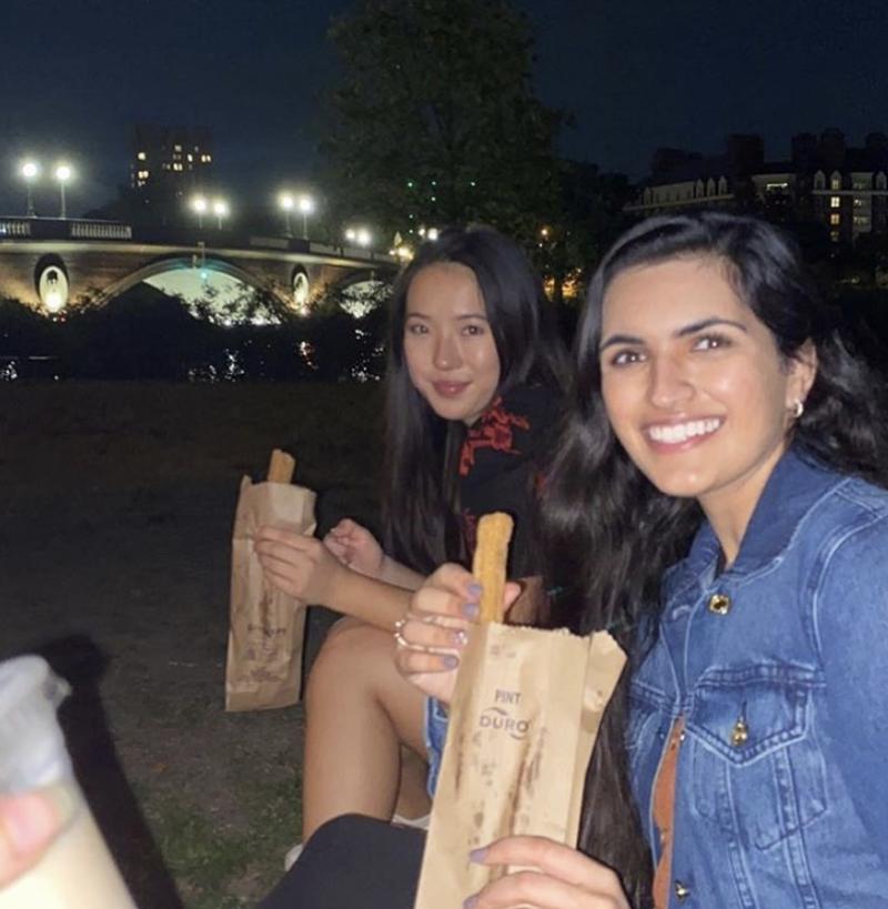 Image of my friends eating churros by the Charles River