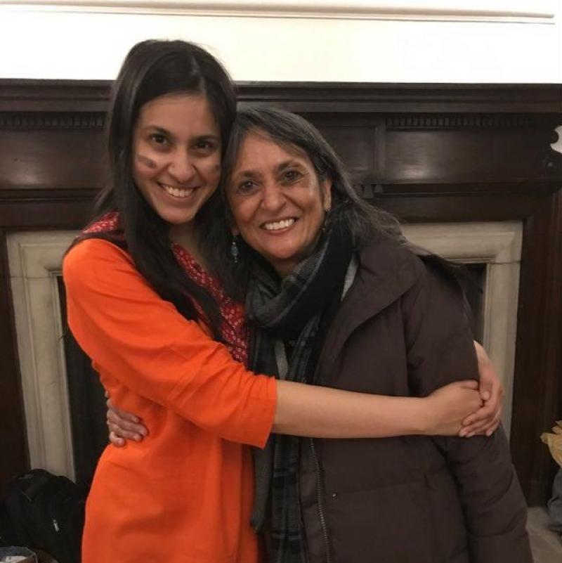 Girl wearing Indian clothes hugging her mother