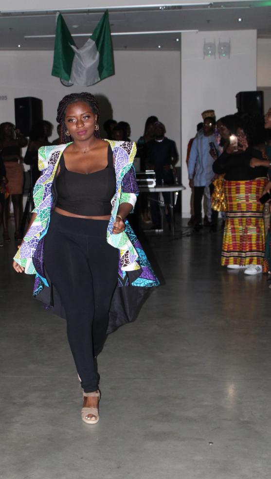 A student wearing an blue ankara blazer walks at NSA Independence Day Gala.