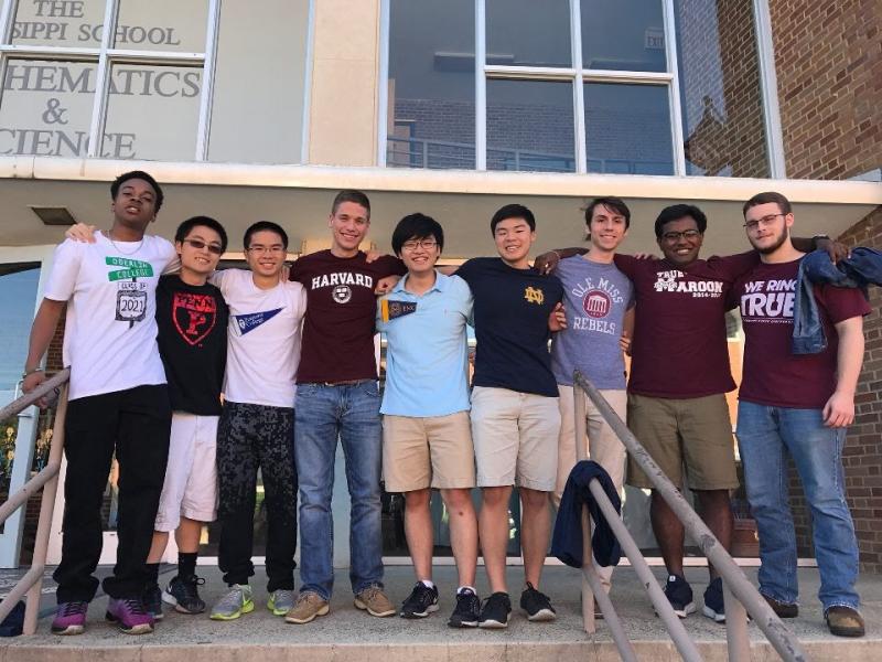A group of students wearing different colleges' attire