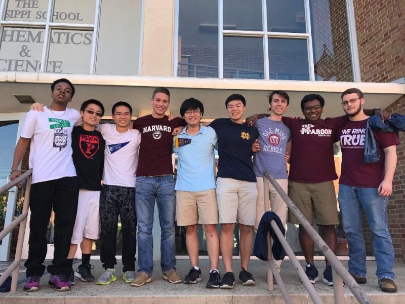 A group of students wearing different colleges&#039; attire