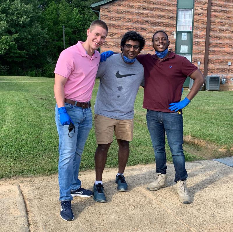 A group of three students posing together