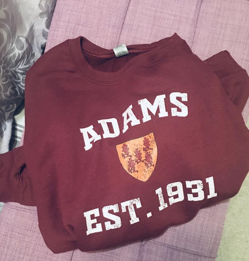 A burgundy Adams sweatshirt with the crest and Est. 1931 on it