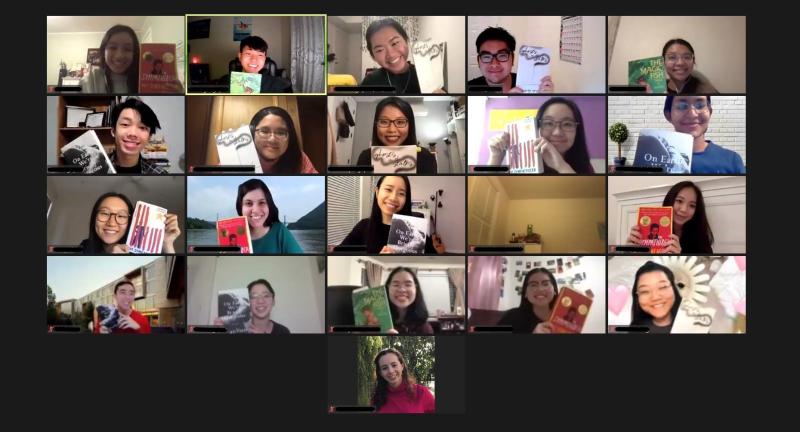 Group of smiling students on Zoom holding up books