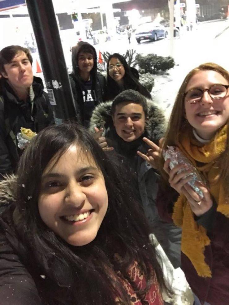 Group of students standing in the snow smiling