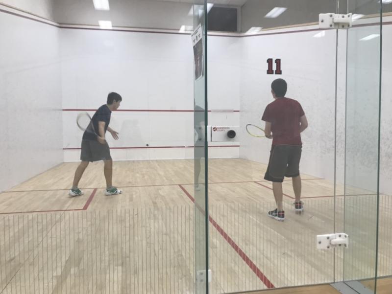 Two students playing squash