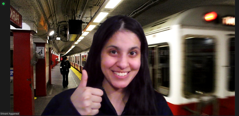 Girl smiling in front of a virtual background of a subway station