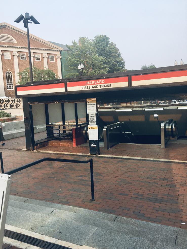 A red line subway entrance in Harvard Square