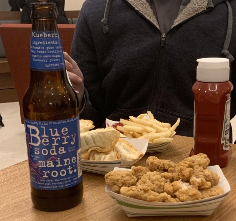 Photo of a blueberry soda, fries, popcorn chicken, and fried dumplings
