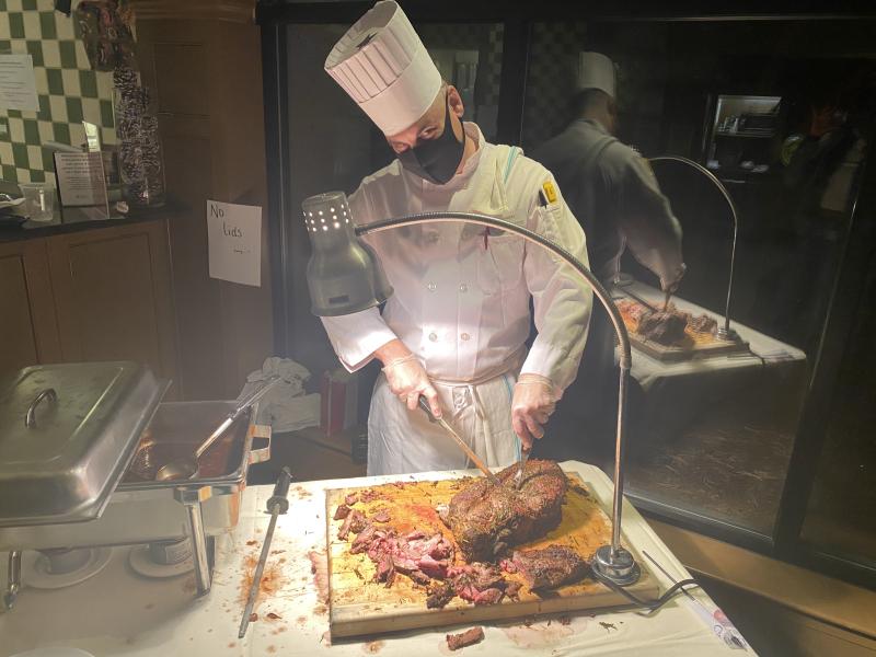 chef cutting into roast beef