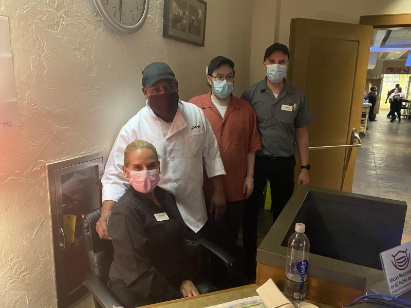 Smiling staff at entrance to dining hall