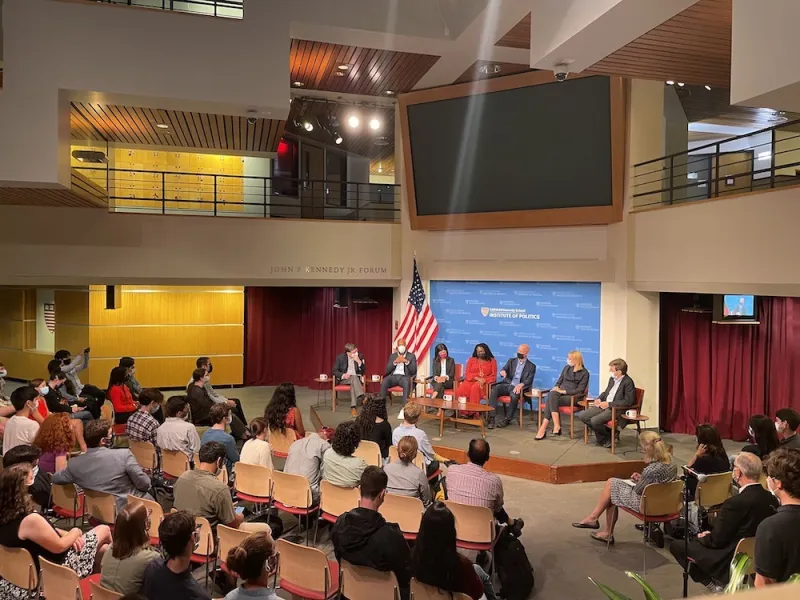 inside room of people and panel of speakers