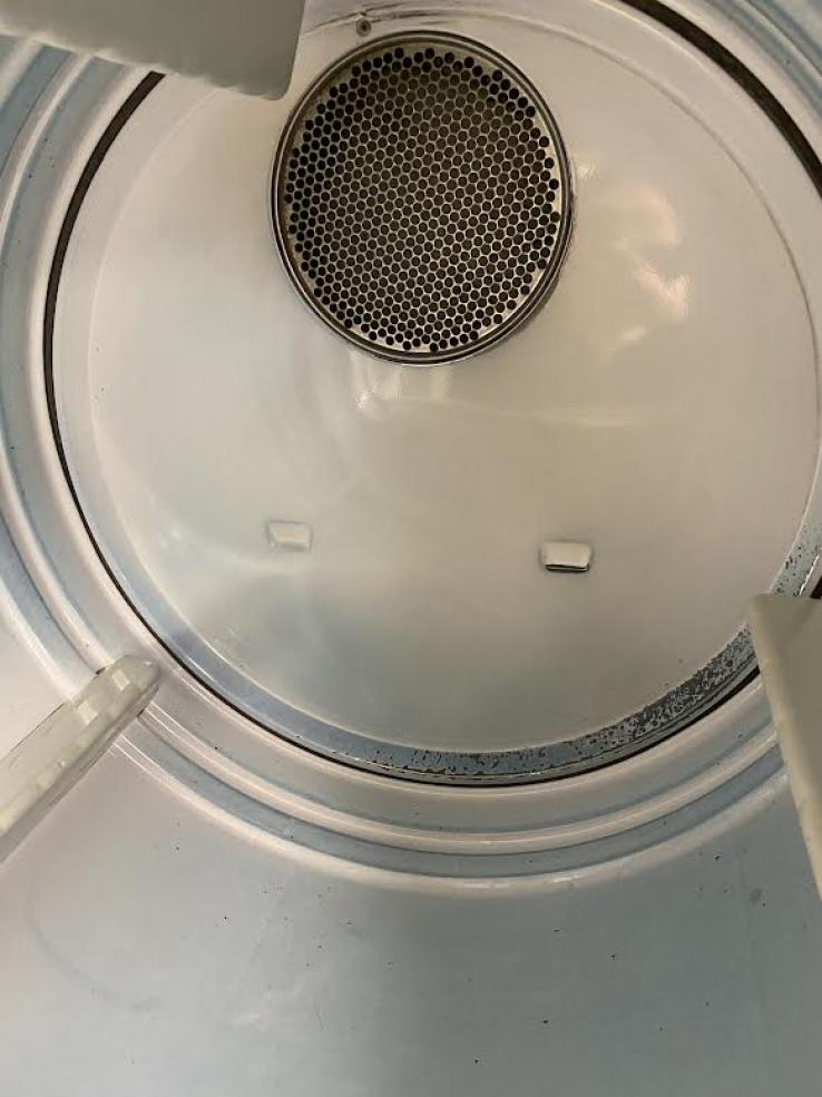 The inside of a dryer; it is pale green.