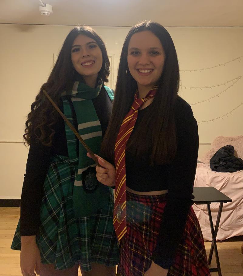 My roommate and I smiling dressed as a Gryffindor and Slytherin students from Hogwarts (Harry Potter).