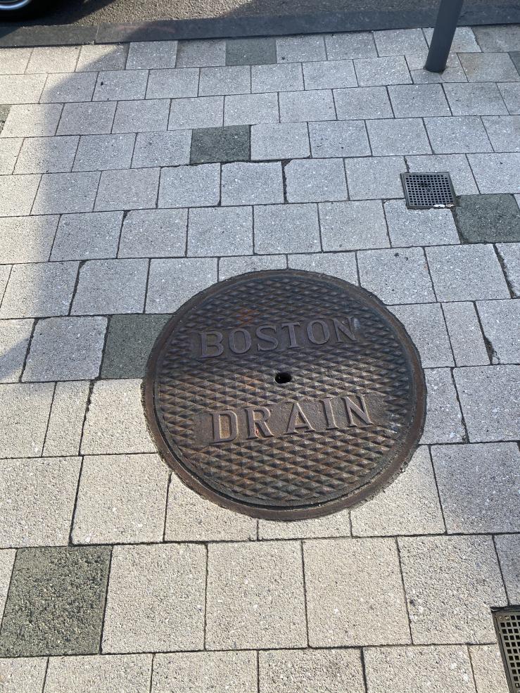 Image of a grate that says "Boston Drain"