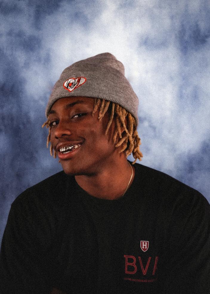 Male student smiling wearing beanie that says Love