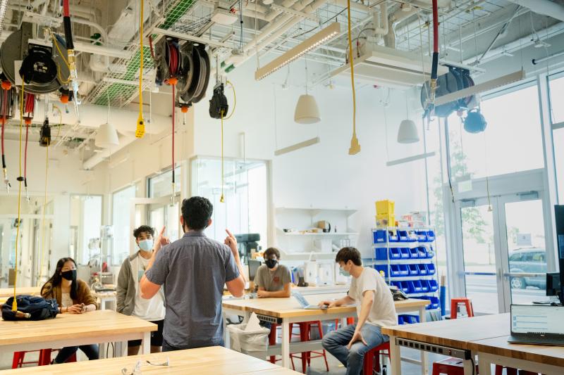 Group of people discussing in a machine shop