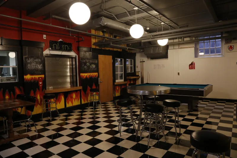 A 90's inspired diner with a pool table and kitchen