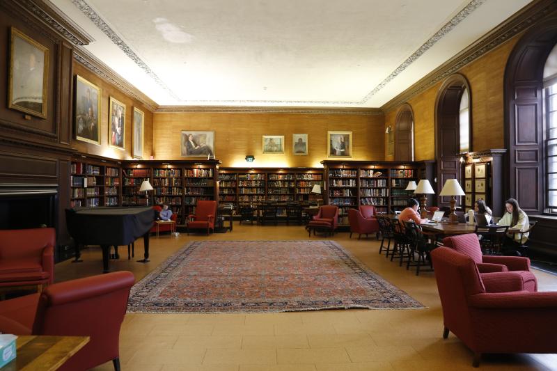 Wide shot of a library showing stacks of books and seating