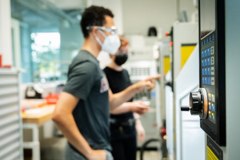 Students in front of a machine