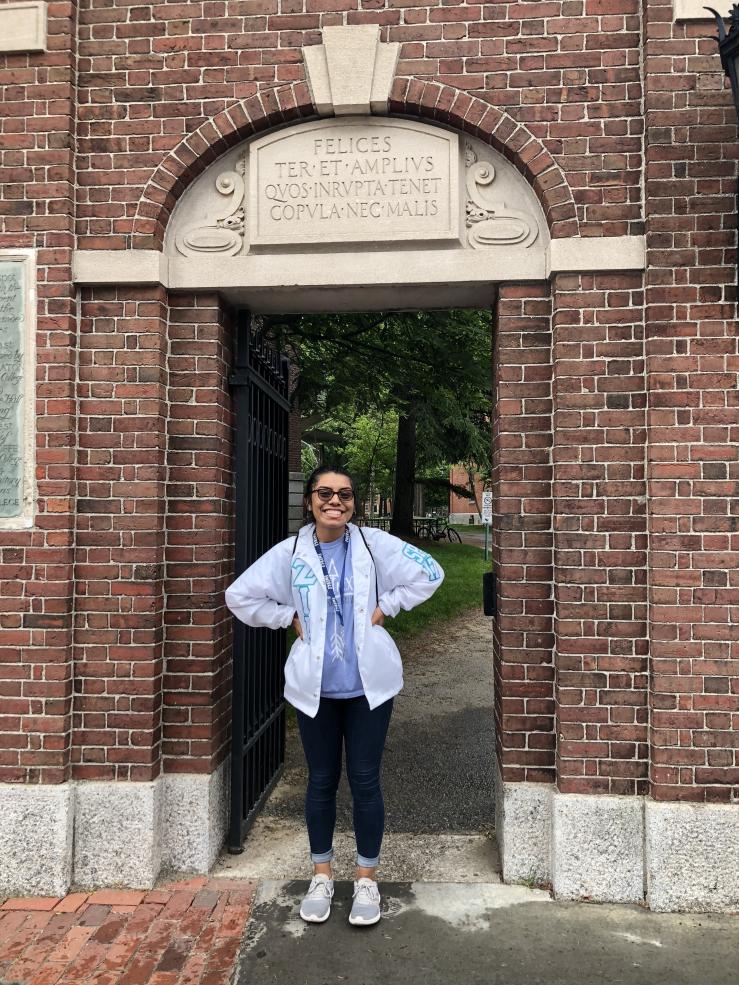 a picture of me during my first trip to Harvard in front of one of the Harvard gates