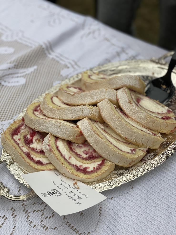 A picture of raspberry roll cakes on a silver platter.