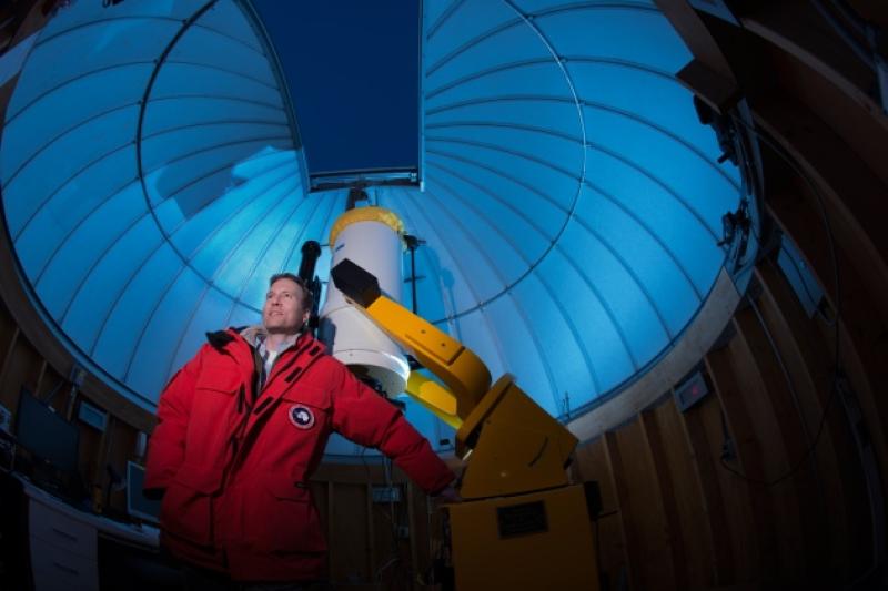 An astronomer in a dome building