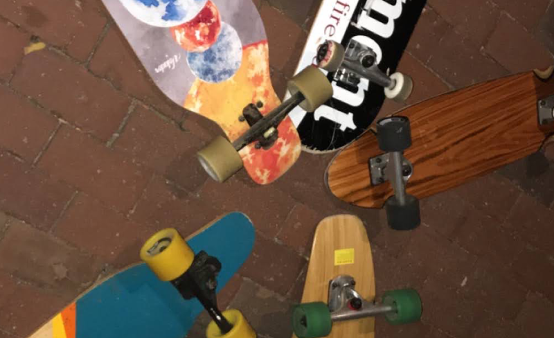 A collection of skateboards all placed near each other.