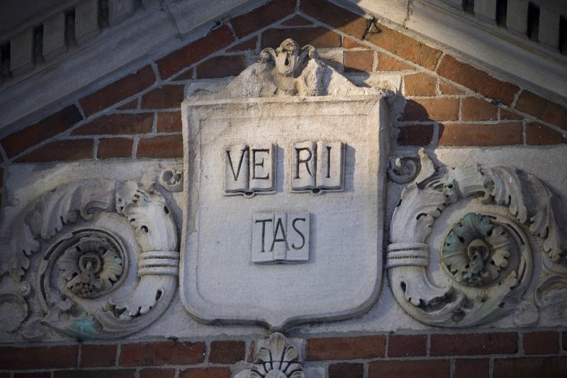 A stone engraving of the word "veritas"