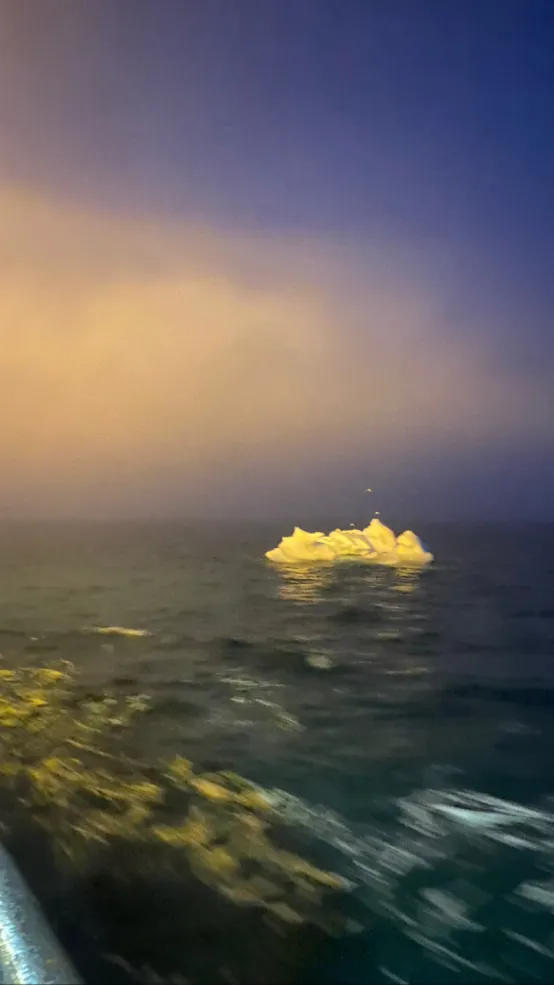 Image of iceberg floating from the side of the boat