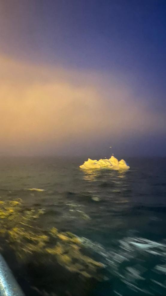 Image of iceberg floating from the side of the boat