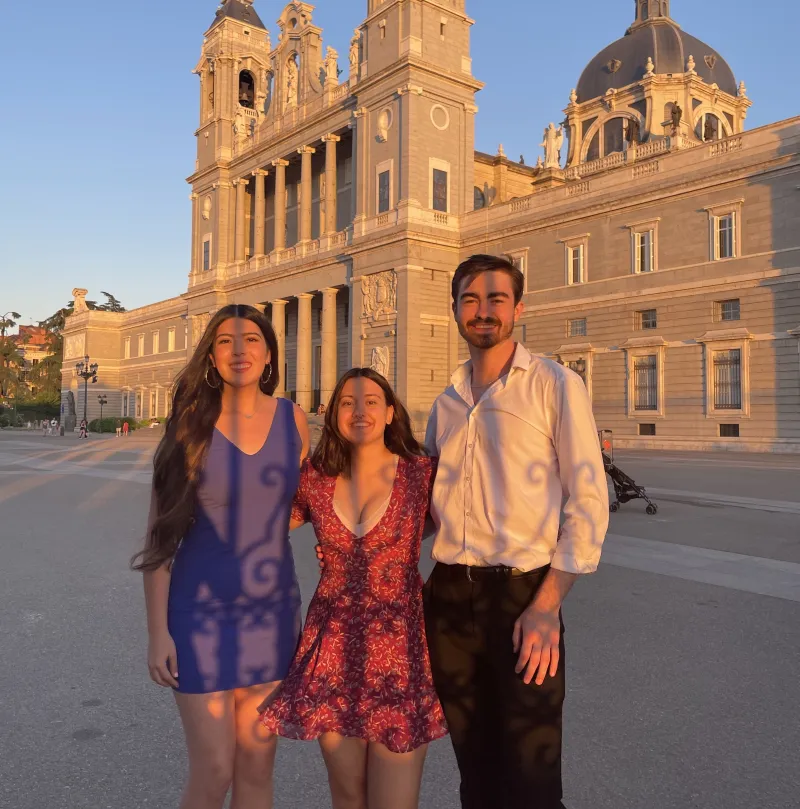 Author and two friends posing in front of the Madrid Cathedral
