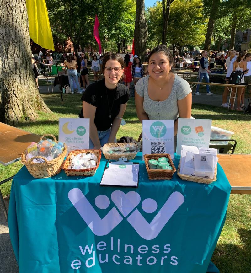 Picture of writer and another WE at their stall in the activities fair