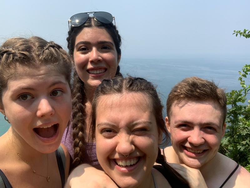 Author and three friends posing for a selfie on a hike