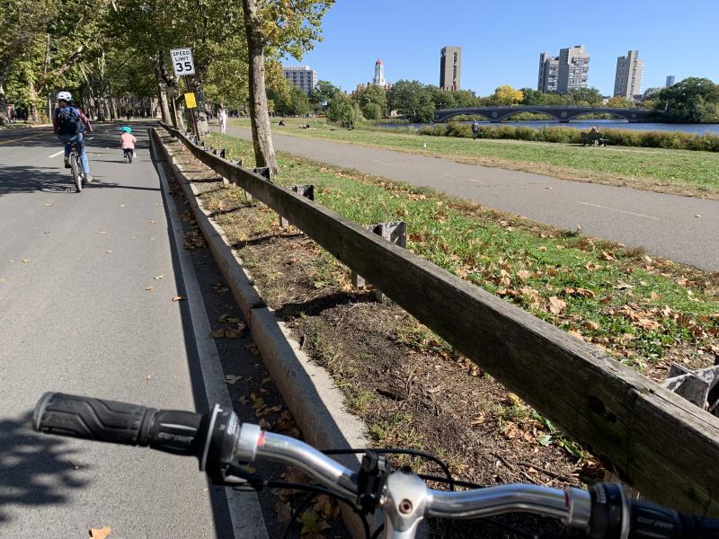 Picture of a writer's bike on Memorial Drive (road) with the view of the Charles River