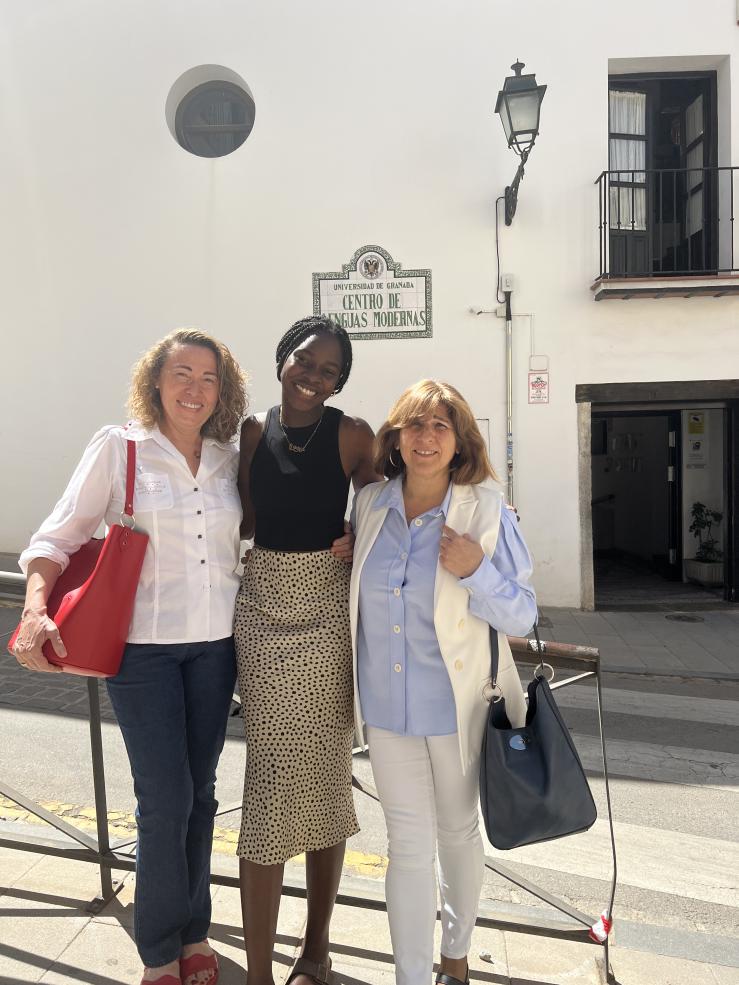 Writer standing and smiling with her two Spanish professors