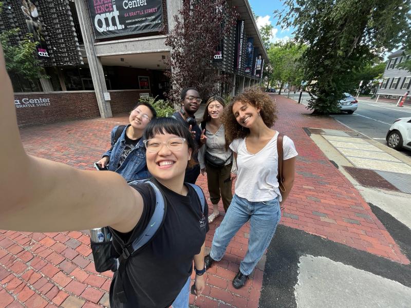 A selfie of five interns in front of the American Repertory Theater