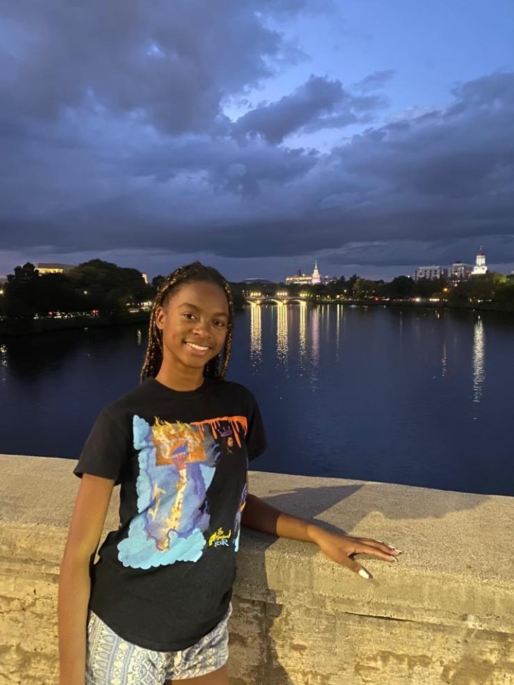 A picture of Jada standing on a bridge overlooking the water. 