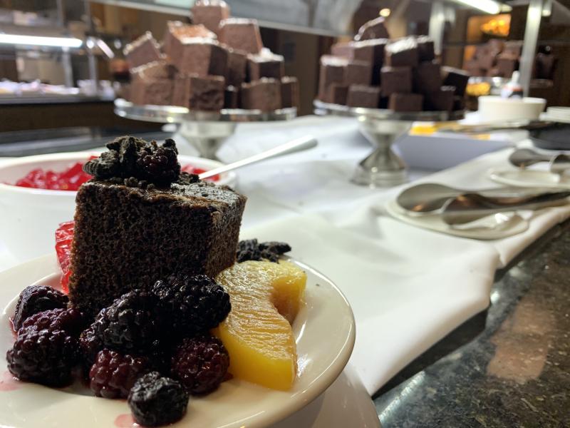 Close up picture of double-fudge choclate cake and fruit