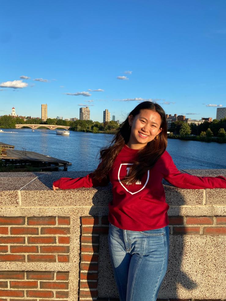 Olivia posing in front of the Charles River