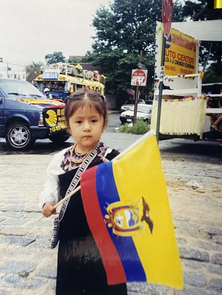 Author posing with Ecuadorian flag at the heritage parade 