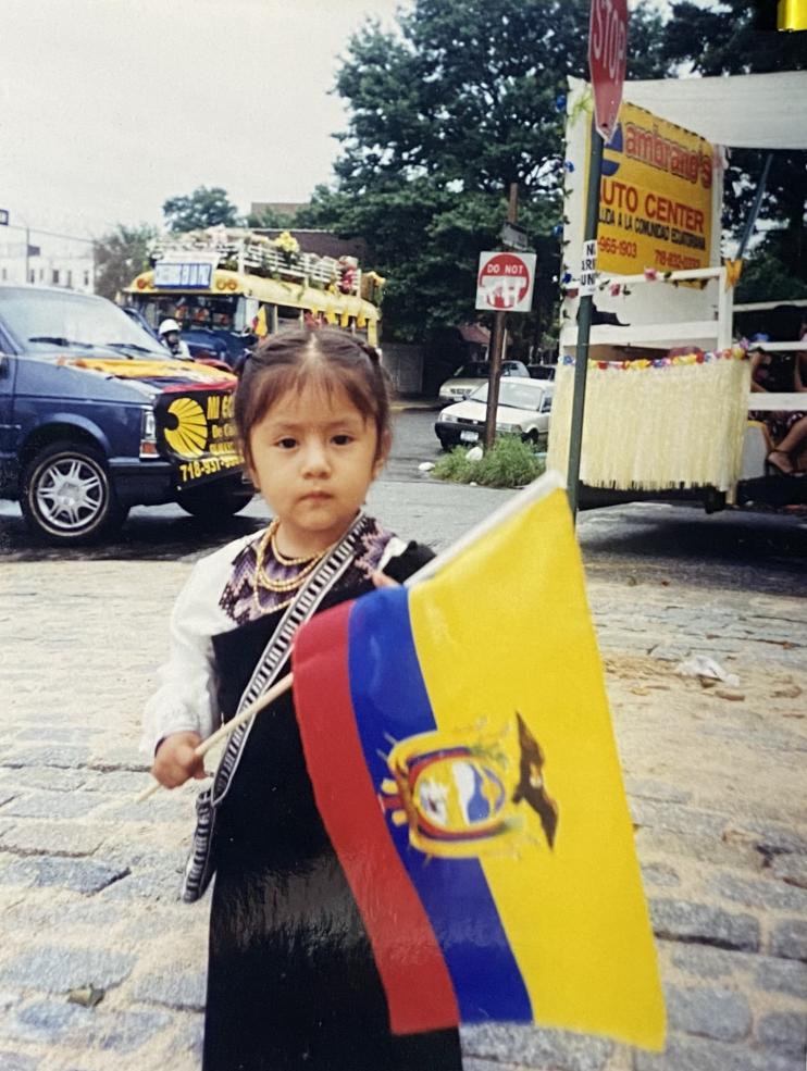 Author posing with Ecuadorian flag at the heritage parade 