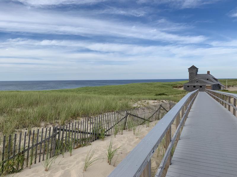 Picture taken from a boardwalk next to the ocean and grass