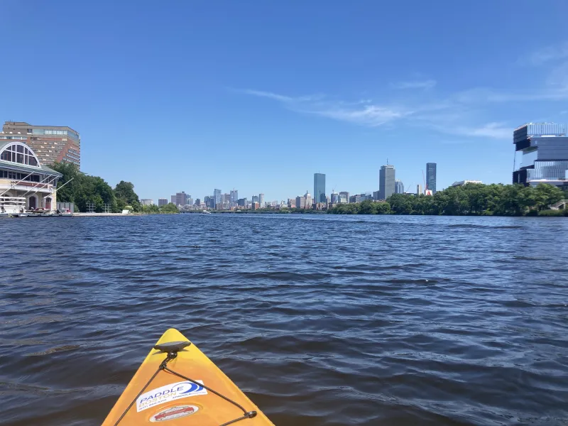 A picture taken from a kayak of the Charles River and Boston skyline