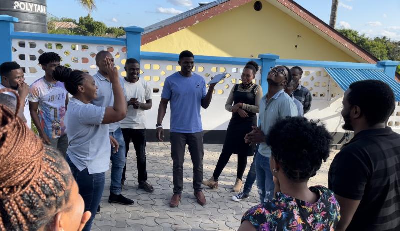 A photo of writer and colleagues standing and playing team building activities