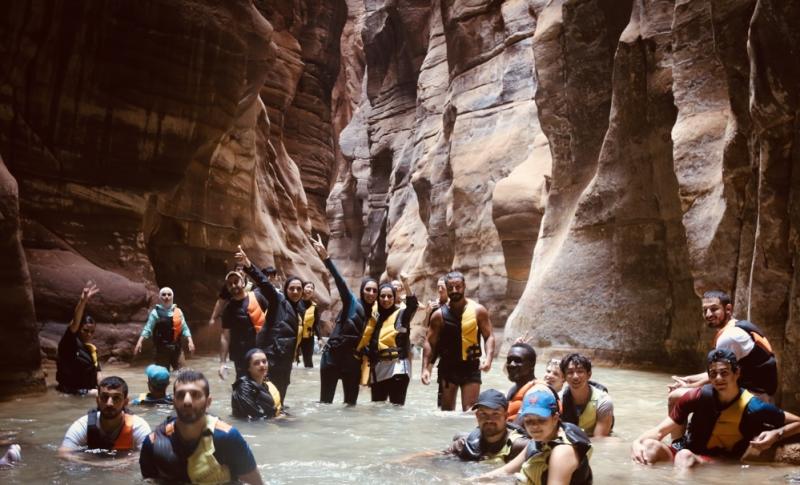 A photo of people in swimming in fresh water pools inside a cave